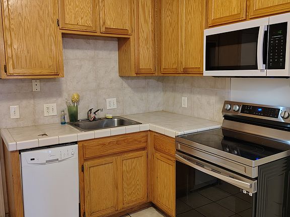 Kitchen with dishwasher, stove, microwave oven