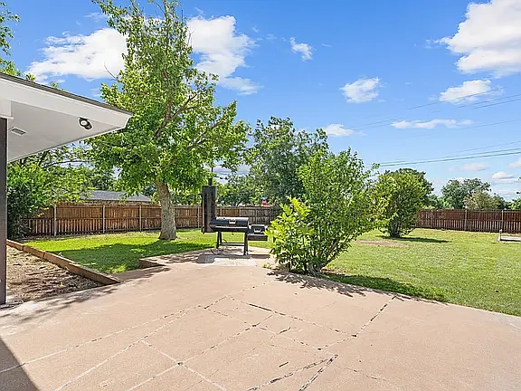 Large Back Yard with patio area for Bar-Be-que pit and back gate to exit and cross over to Elm Creek Park, 11 acres of walking trails, a pavilion, benches, and passive work-out equipment.