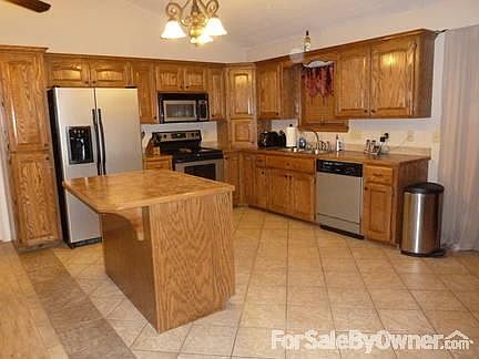 Kitchen
						:
						Open floor plan, custom-made cabinets with hidden lights, movable bar island