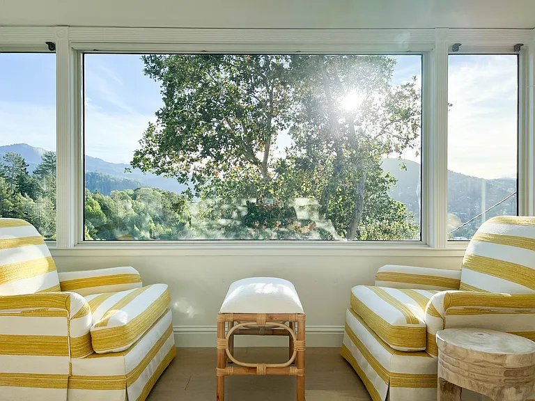 Primary Bedroom furnished with King Size bed, cozy club chairs in the bay window, and a large chest of drawers.
The Primary also has a private entrance.