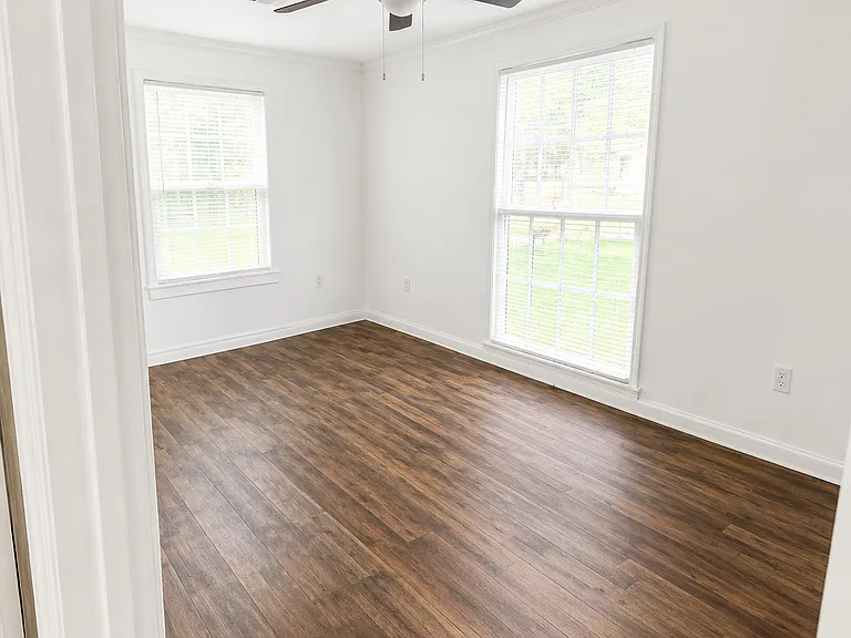 Bedroom #1 - Original window and new window for ample lighting and fresh air. New flooring and ceiling fan. 

Photo Note: Photos have been lightly enhanced to improve lighting and image quality. Colors, finishes, and exterior conditions may vary slightly.