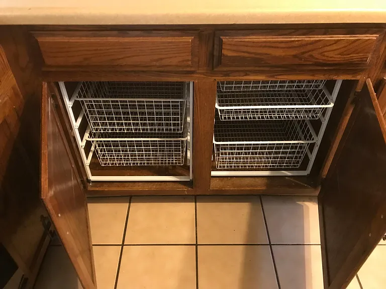 Pullout storage drawers in cabinets.