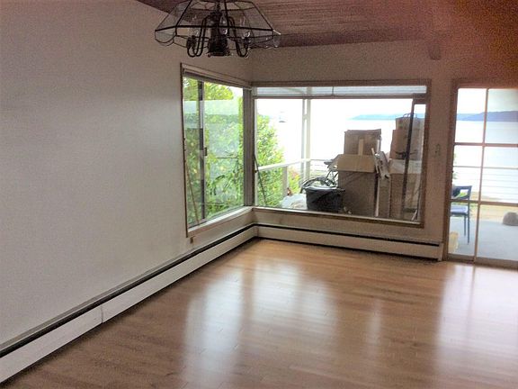 Dining room chandelier and view of windows and hardwood floor