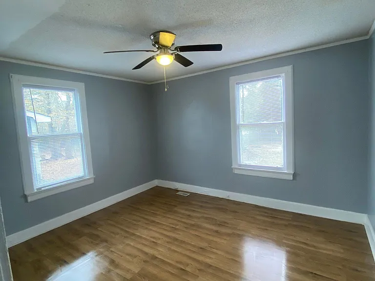 Large bedroom with hardwood flooring
