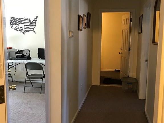 Inside the front entrance looking down hall towards back door of the unit.