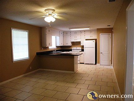 Dining room w/ kitchen in background, ceramic tile floors