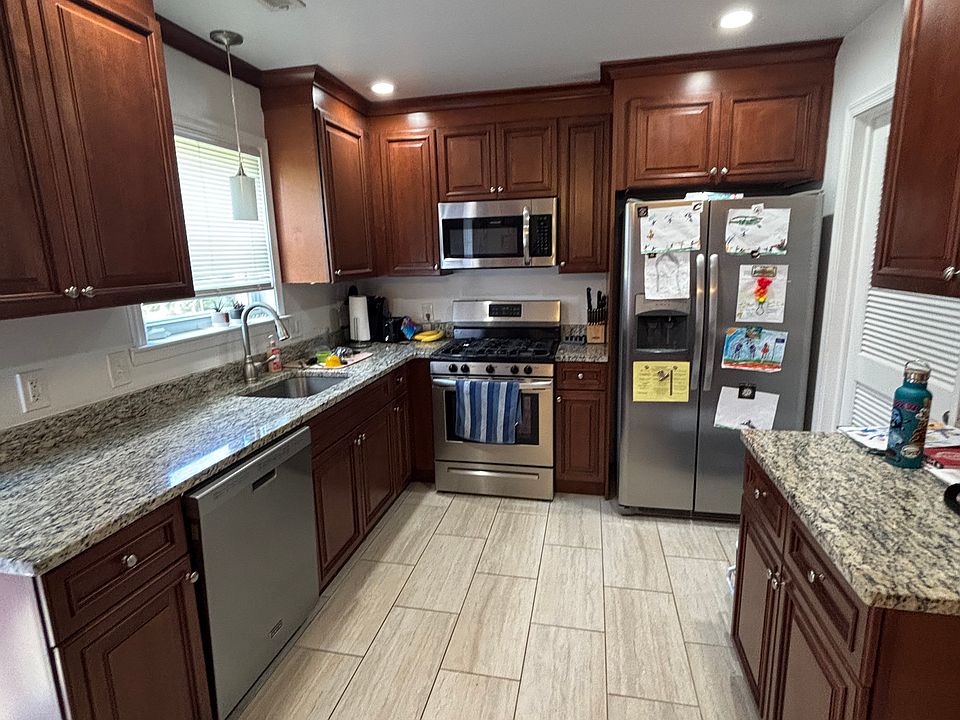 Kitchen with Stainless Steel Appliances, garbage disposal, and refrigerator with built in water & ice maker.