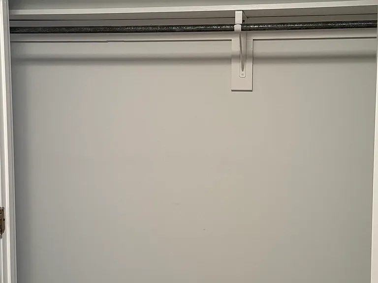 Guest bedroom has 8' wide closet with shelving and clothes hanging ability.