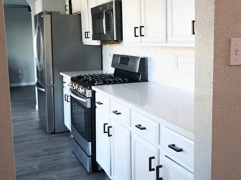 Kitchen view. Refrigerator, microwave range, stove, dish washer, water filtration system included.