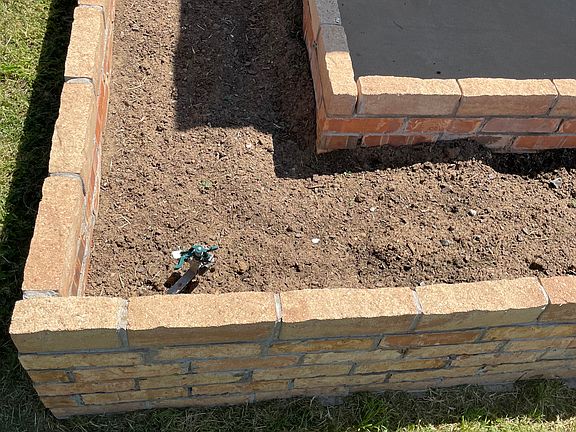 Brick flowerbed at front area if the house.