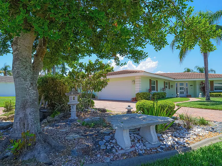 Front of house - two car garage, large driveway to accomodate two additional vehicles