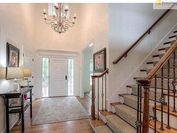 Front Entry, beautiful designer chandelier with intricate detailing.