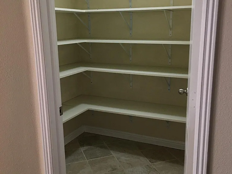 Built in custom shelves in large walk in pantry