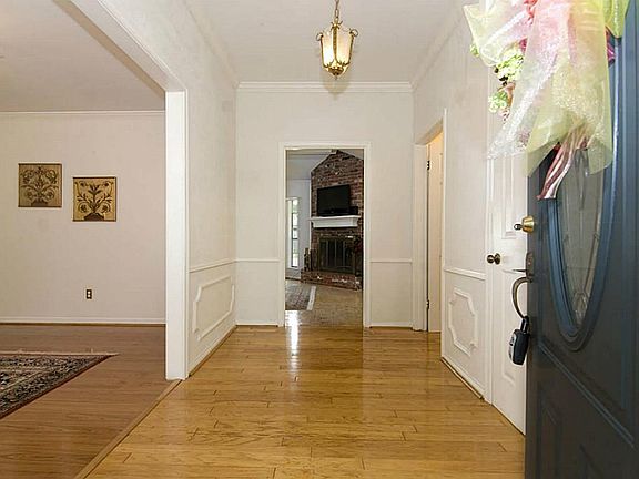 The leaded glass door opens to hardwood laminate flooring.
