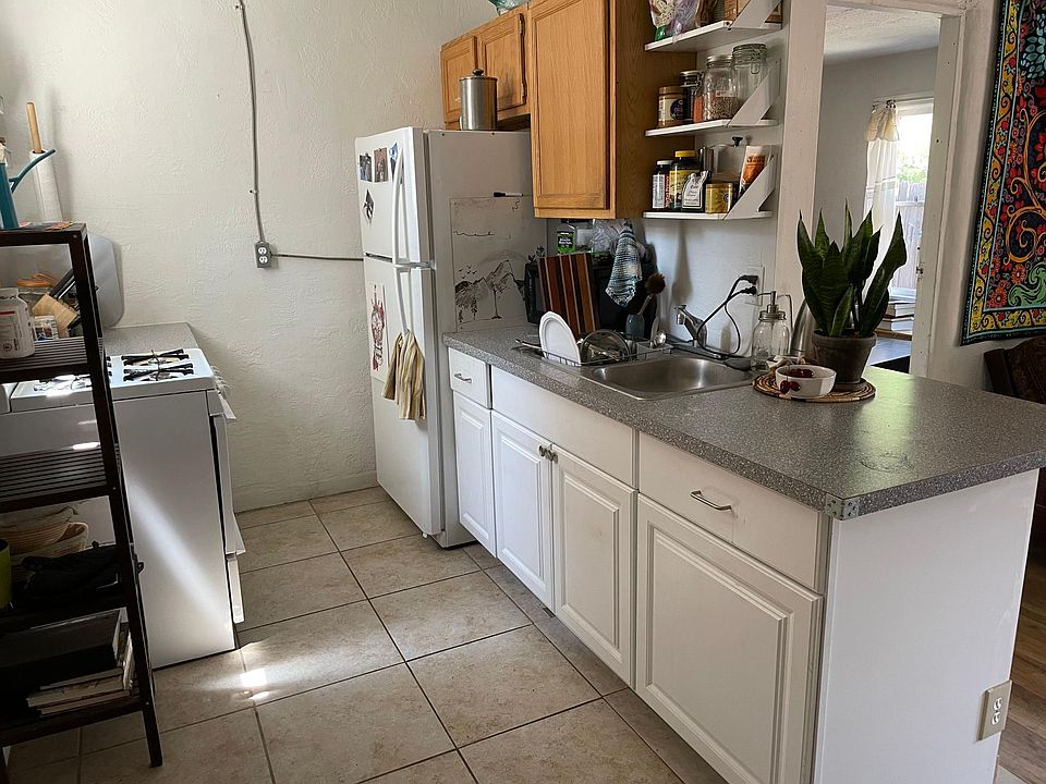 Open kitchen plan has small island that connects to living room.