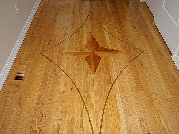 In laid hardwood flooring at entry with closet and covered porch