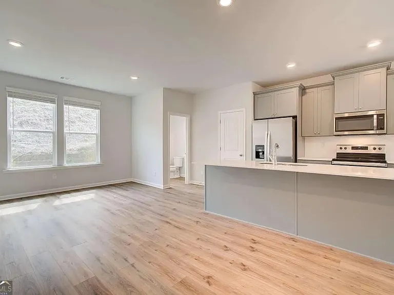 Kitchen, dining area, and powder room