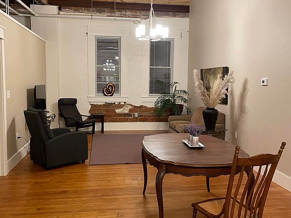 Open dining room and living room. Plenty of space for a large table as well as a full set of living room furniture.