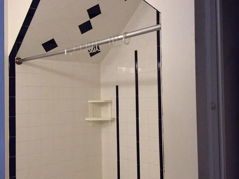 Unique tiled bath with W/D in closet (unseen in the image)