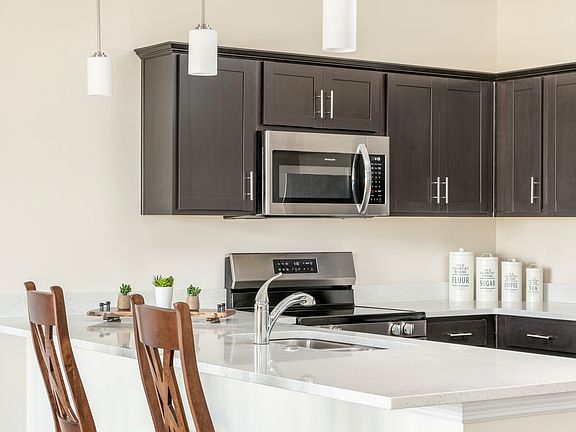 Beautiful kitchen with granite countertops, stainless appliances, a breakfast bar, pantry and lots of cabinets.