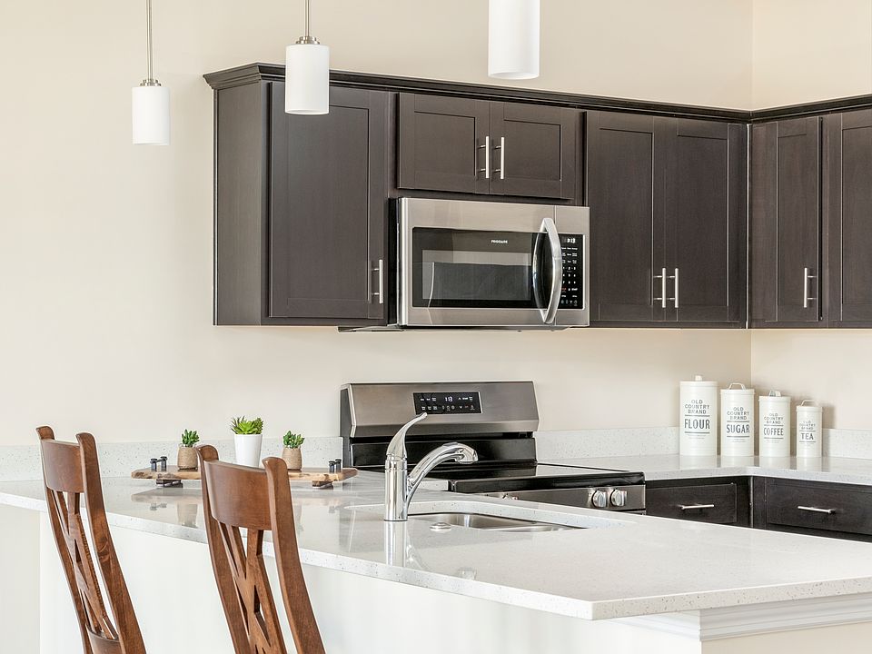 Beautiful kitchen with granite countertops, stainless appliances, a breakfast bar, pantry and lots of cabinets.