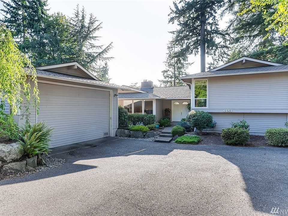 Large driveway with lots of parking and detached garage to the left.  11 foot ceilings for RV parking as well!