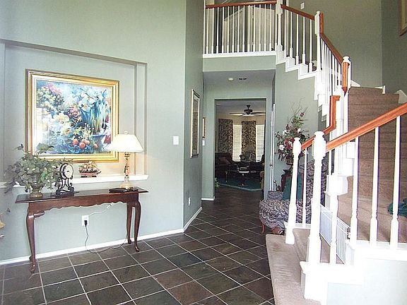 Spacious foyer with two story ceiling and art niche. Stunning slate floors extend through entry, dining, study and family room!