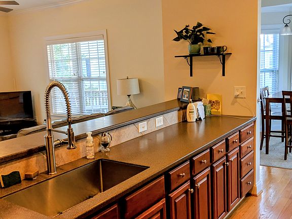 Galley kitchen oversees living spaces