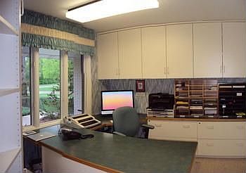 Main floor office with builtin desk, file cabinets and lots of storage. Samsung room air conditioner