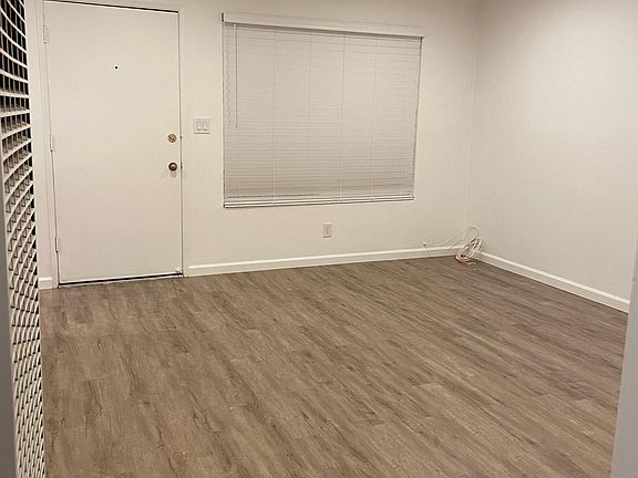 Brand new plank flooring and recessed lighting throughout living room and kitchen