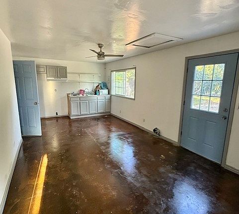 Looking at Living Room, Entry Door and Kitchen area - acid etch floor and new paint throughout