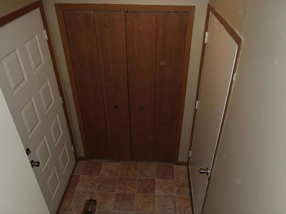 Entryway with closet, entry from garage on right and front door on left
