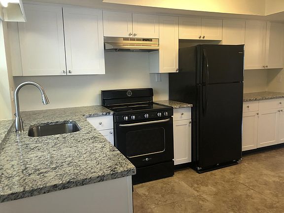 Brand new kitchen with beautiful white shaker cabinets, white ornamental granite stone, large floor tiles, newer dishwasher and fridge, upgraded stove.