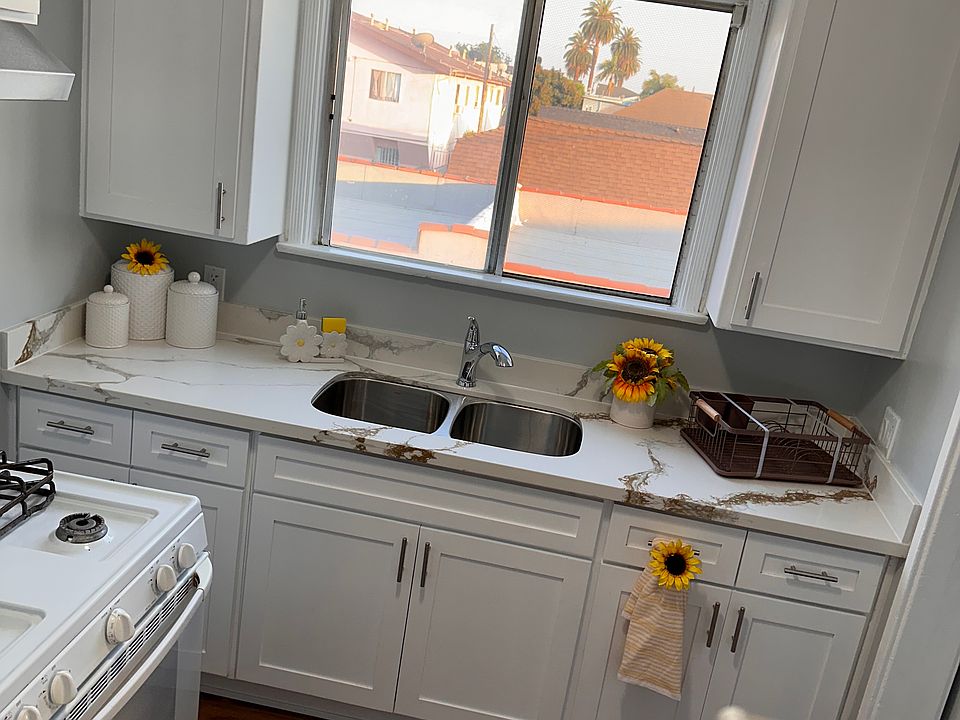 Kitchen with qaurz countertop and stainless steel double sink.