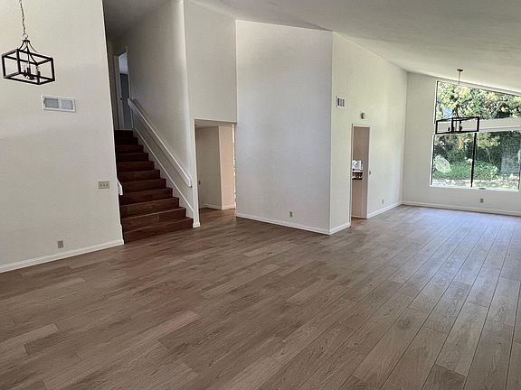 view from living room into dining room and up stairs towards bedrooms.