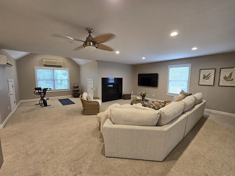 View from dining area. Flex space for workout area or office space. Direct vent gas fireplace with granite surround. New 65" Samsung Smart TV.