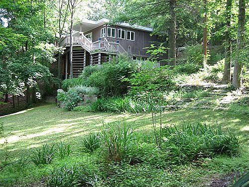house surrounded by trees and terraced gardens
