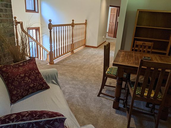 Looking from living/dining area toward hallway and stairway leading down one flight to apartment's dedicated deck space and one more flight down to main entrance.