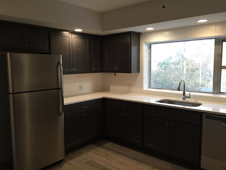 Kitchen with stainless refrigerator