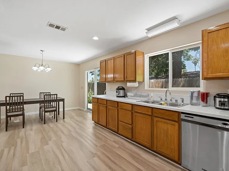 Indulge in home-cooked meals and shared moments at our pristine kitchen and dining area, where modern amenities meet cozy ambiance for an unforgettable dining experience.
