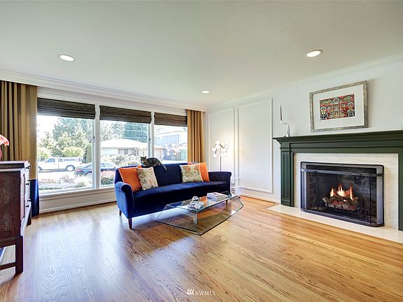 Relax by the wood burning fireplace in the living room. Wainscoting and crown molding add character and charm along with the beautiful hardwood floors.