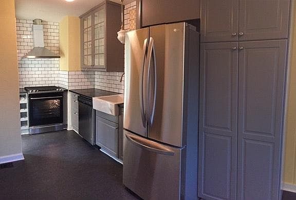 Brand new kitchen with stainless appliances, custom tile and
