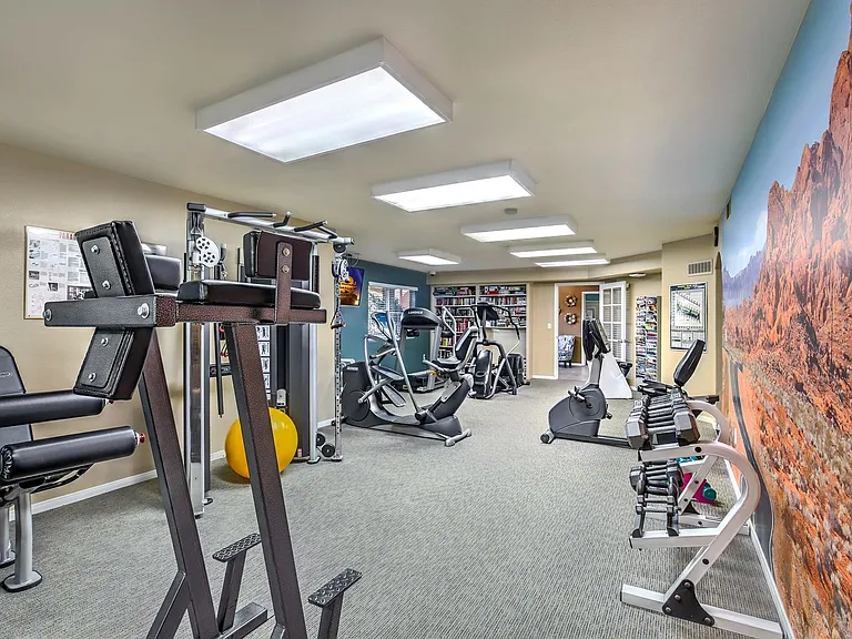 Resident fitness center with free weights, cardio machines, and weight machines.