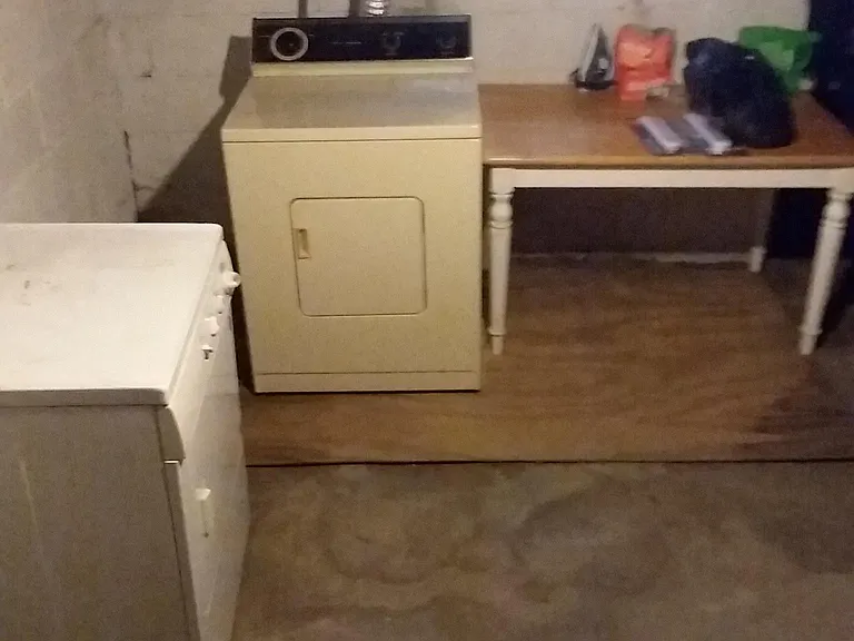 Clean well lit basement for shared laundry with the upper