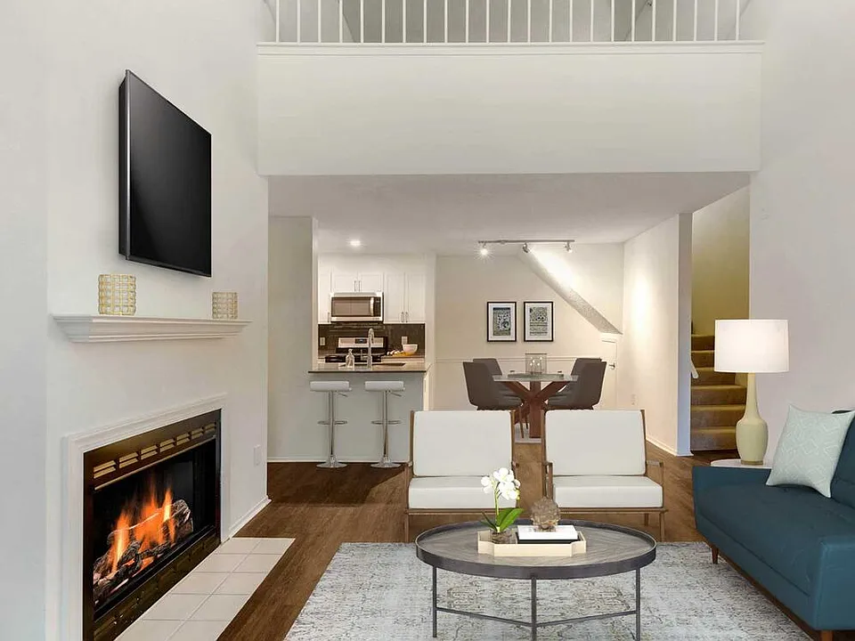 Renovated Package I kitchen, living, and dining areas with hard surface plank flooring