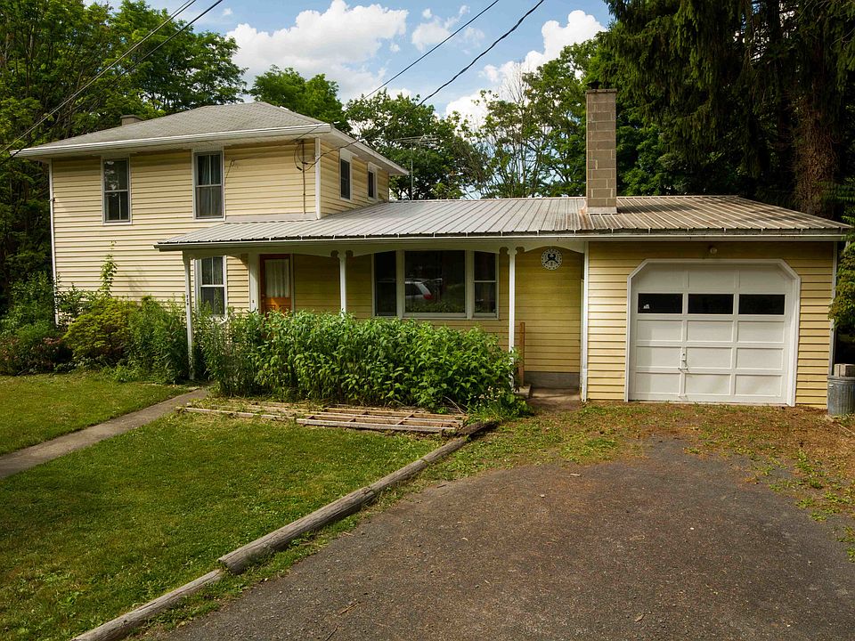 Front yard and garage. Driveway fits three comfortably, plus