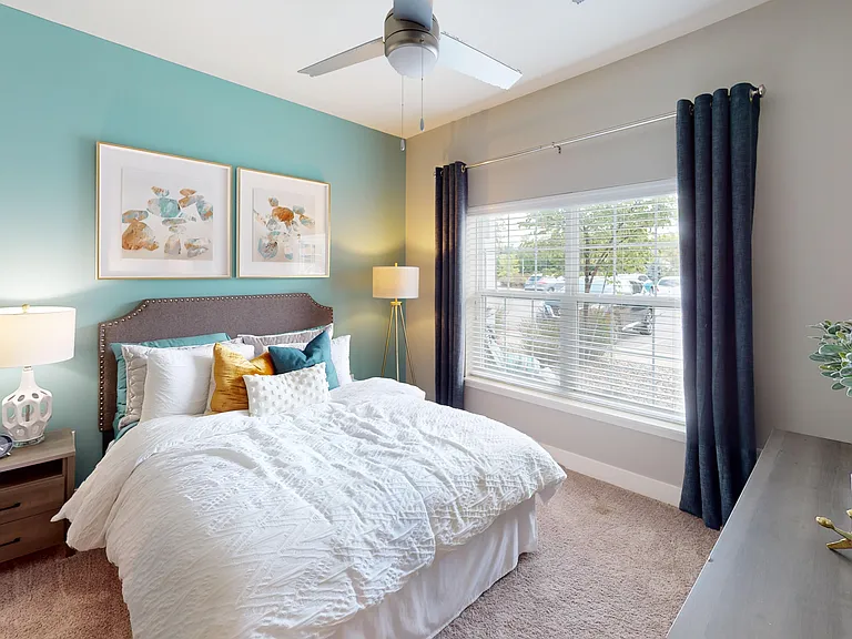 A peaceful bedroom retreat made even better by a large window that fills the space with warm, natural light.