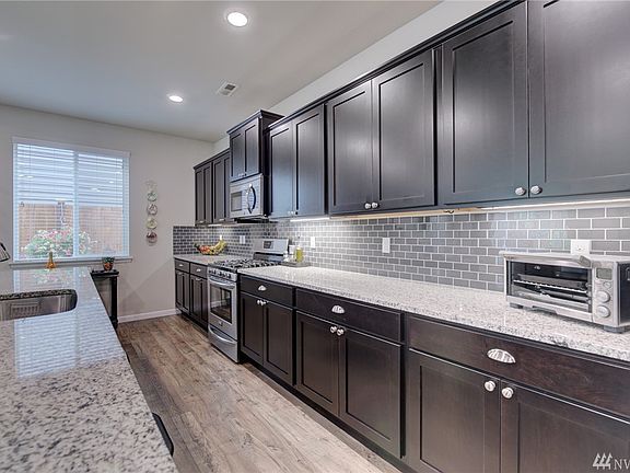 Beautiful Espresso cabinets, soft close doors and drawers, granite surfaces and subway tile backsplash - Perfect!