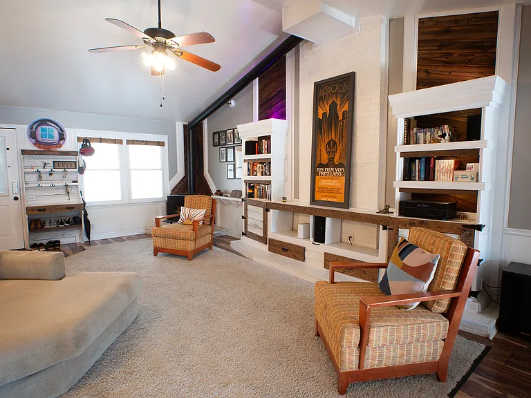 Living room with light up built ins + faux fireplace. Inquire about fully furnished option.