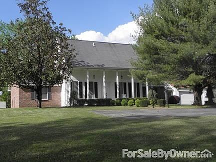 Back of home. View of sun porch
						:
						Windows on back porch are double insulated and will rock out for cleaning